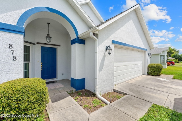 878 Croton Rd, Rockledge, FL 32955 - entrance to property with a garage, stucco siding, and driveway
