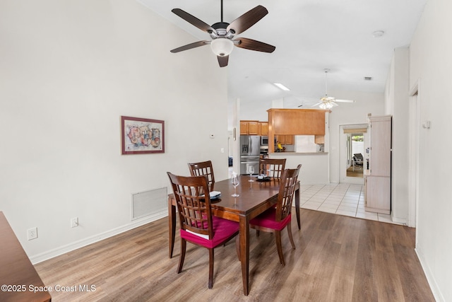 878 Croton Rd, Rockledge, FL 32955 - dining area with a ceiling fan, light wood finished floors, and high vaulted ceiling