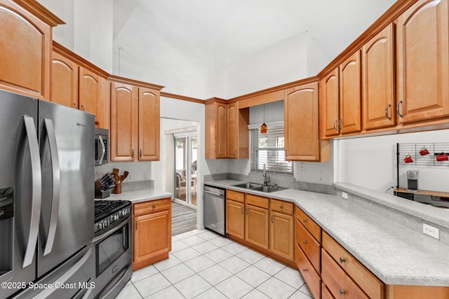 878 Croton Rd, Rockledge, FL 32955 - kitchen featuring appliances with stainless steel finishes, light countertops, light tile patterned floors, and brown cabinetry