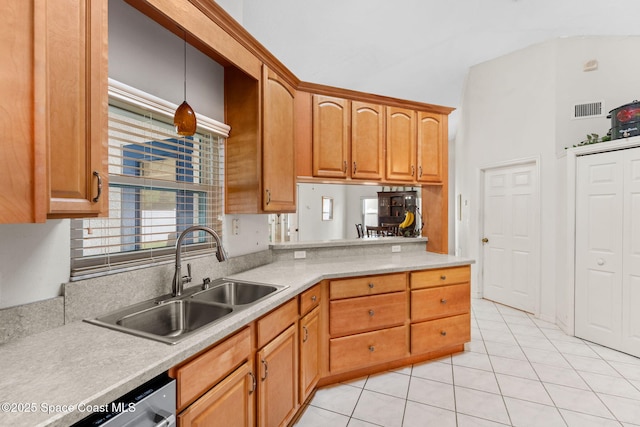 878 Croton Rd, Rockledge, FL 32955 - kitchen featuring light tile patterned floors, light countertops, dishwasher, and brown cabinets