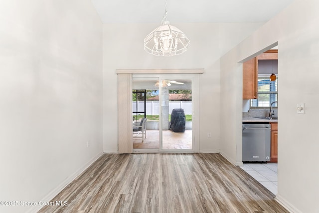 878 Croton Rd, Rockledge, FL 32955 - unfurnished dining area with light wood-style floors, a chandelier, and plenty of natural light