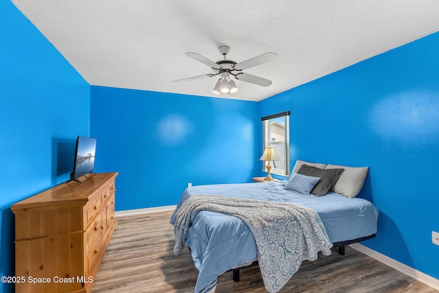 878 Croton Rd, Rockledge, FL 32955 - bedroom with wood finished floors, a textured ceiling, and a ceiling fan