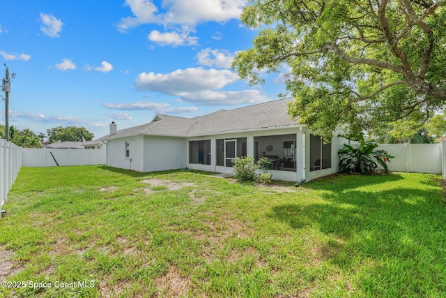 878 Croton Rd, Rockledge, FL 32955 - back of house featuring a sunroom, a fenced backyard, a shingled roof, and stucco siding