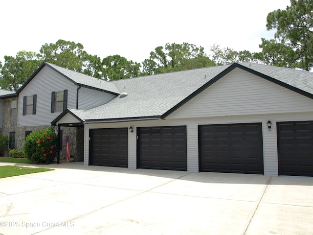 9020 York Ln Unit C, West Melbourne, FL 32904 - view of front of home featuring an attached garage, driveway, and roof with shingles