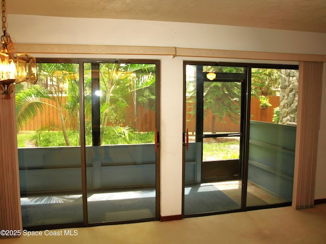 9020 York Ln Unit C, West Melbourne, FL 32904 - doorway to outside with a chandelier