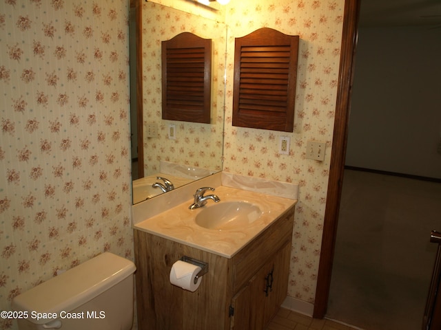 9020 York Ln Unit C, West Melbourne, FL 32904 - bathroom with wallpapered walls, vanity, and tile patterned floors