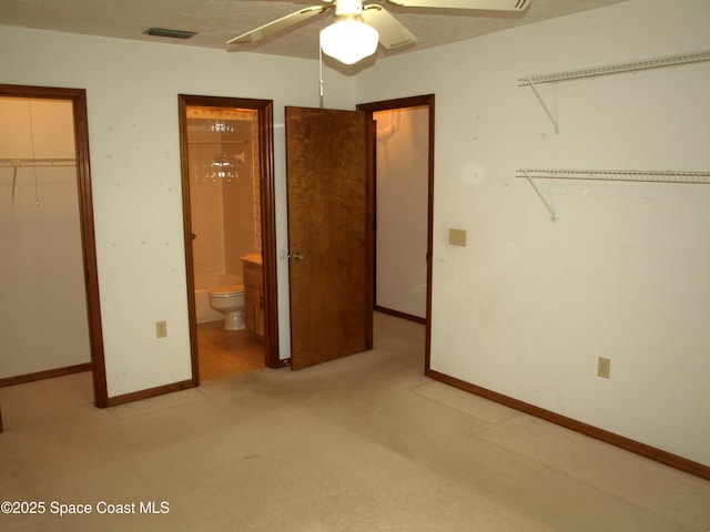 9020 York Ln Unit C, West Melbourne, FL 32904 - unfurnished bedroom with a spacious closet, a closet, carpet flooring, ensuite bath, and ceiling fan