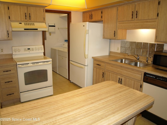 9020 York Ln Unit C, West Melbourne, FL 32904 - kitchen with white appliances, custom range hood, washer and dryer, and light countertops