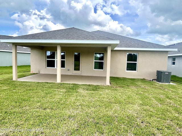 1245 Kylar Dr NW, Palm Bay, FL 32907 - rear view of property with a patio area, roof with shingles, a yard, and stucco siding