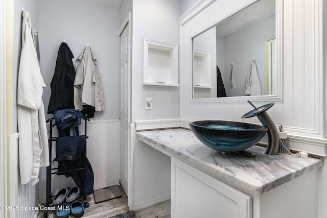2606 Tepee Ave SE, Palm Bay, FL 32909 - bathroom with wood finished floors, vanity, and a wainscoted wall