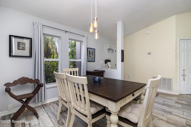 2606 Tepee Ave SE, Palm Bay, FL 32909 - dining room with light wood-style flooring and a textured ceiling