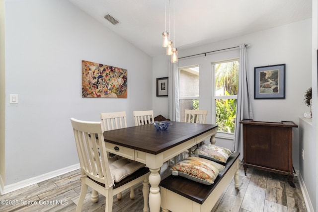 2606 Tepee Ave SE, Palm Bay, FL 32909 - dining area featuring light wood-type flooring and lofted ceiling