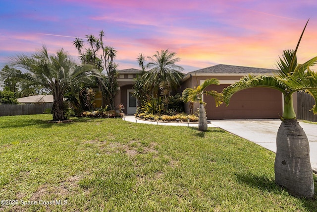 2606 Tepee Ave SE, Palm Bay, FL 32909 - view of front of house featuring concrete driveway, an attached garage, and stucco siding