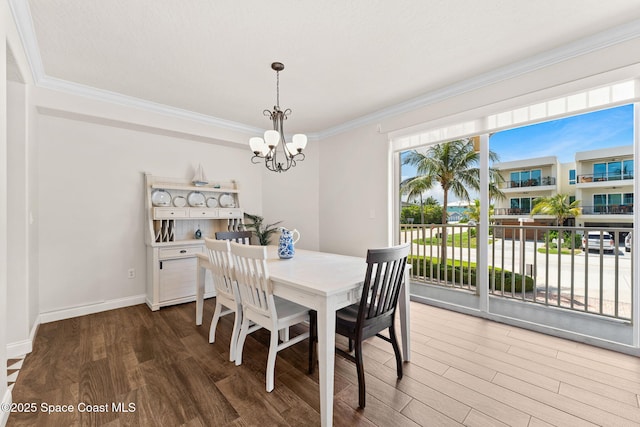 1 Eighth Ave Unit 1201, Indialantic, FL 32903 - dining space featuring wood finished floors, a chandelier, and crown molding