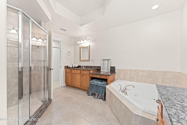 1 Eighth Ave Unit 1201, Indialantic, FL 32903 - full bath featuring vanity, a jetted tub, a shower stall, and tile patterned floors