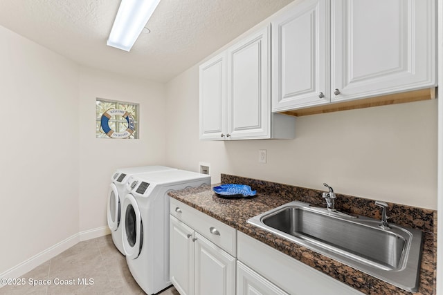 1 Eighth Ave Unit 1201, Indialantic, FL 32903 - washroom with cabinet space, washer and clothes dryer, a textured ceiling, and light tile patterned floors
