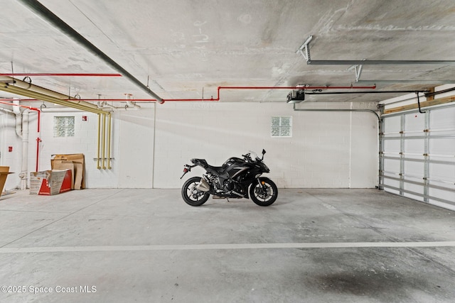 1 Eighth Ave Unit 1201, Indialantic, FL 32903 - garage featuring concrete block wall and a garage door opener