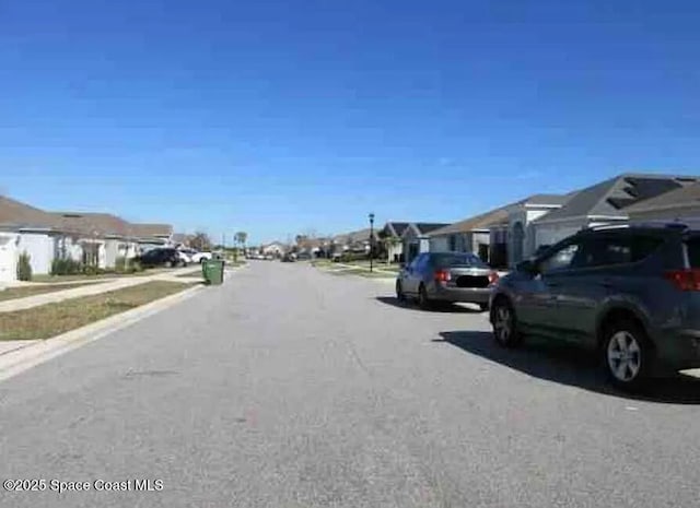 837 Cambridge Dr, Winter Haven, FL 33881 - view of asphalt road with a residential view, sidewalks, and curbs