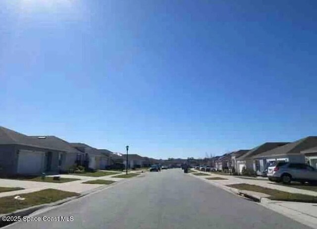 837 Cambridge Dr, Winter Haven, FL 33881 - view of asphalt street with a residential view, sidewalks, and street lighting