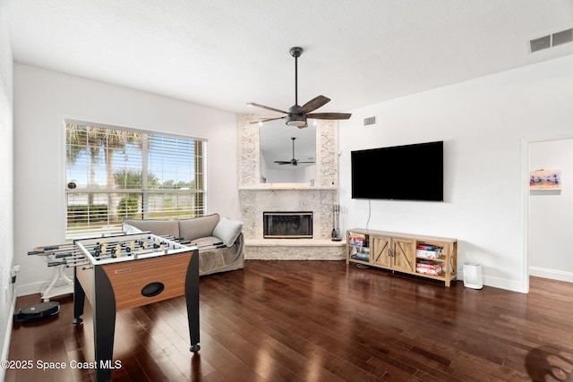 405 Lake View Ln, Grant-Valkaria, FL 32909 - playroom featuring a ceiling fan, a stone fireplace, and wood finished floors
