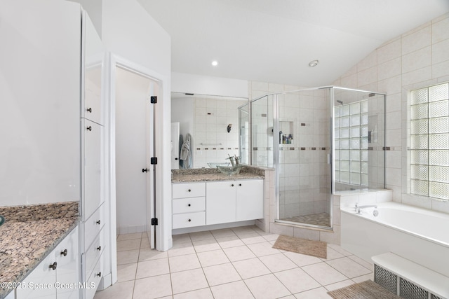 405 Lake View Ln, Grant-Valkaria, FL 32909 - full bath featuring vanity, a stall shower, tile patterned flooring, a bath, and vaulted ceiling