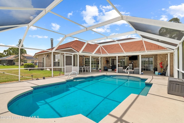 405 Lake View Ln, Grant-Valkaria, FL 32909 - outdoor pool with a patio area, glass enclosure, and a lawn