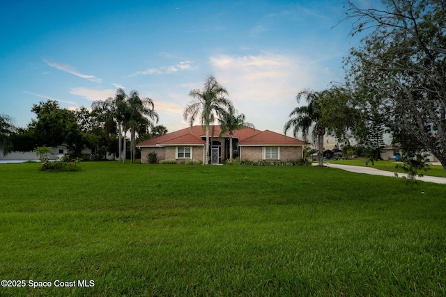 405 Lake View Ln, Grant-Valkaria, FL 32909 - ranch-style home featuring a front lawn and brick siding