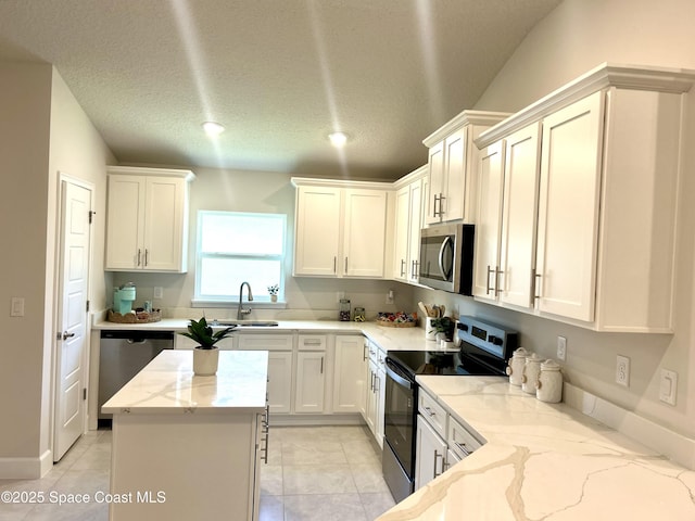 1225 Kylar Dr NE, Palm Bay, FL 32907 - kitchen featuring stainless steel appliances, light stone countertops, white cabinetry, and recessed lighting