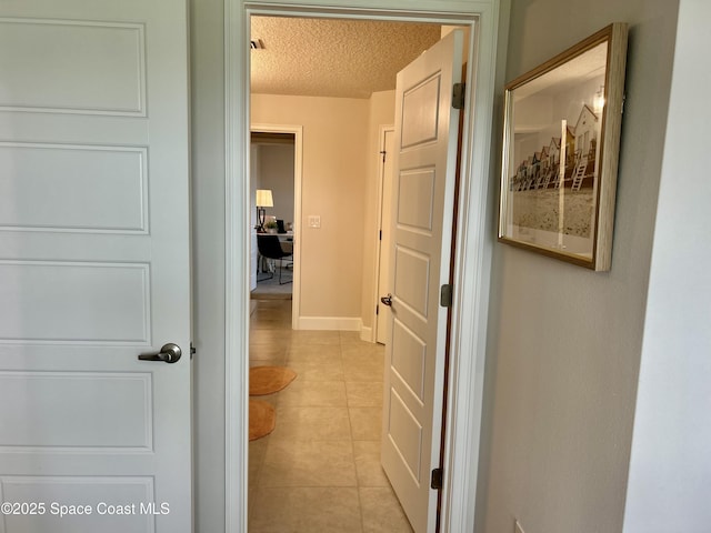 1225 Kylar Dr NE, Palm Bay, FL 32907 - hall featuring a textured ceiling, light tile patterned floors, and a desk