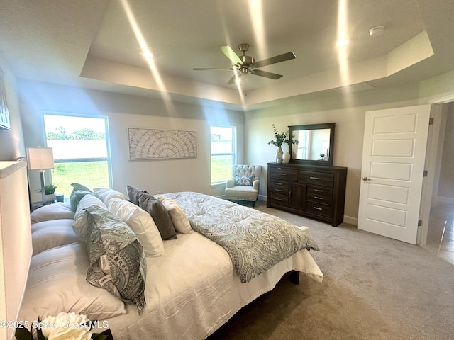 1225 Kylar Dr NE, Palm Bay, FL 32907 - bedroom featuring a raised ceiling, light colored carpet, and a ceiling fan