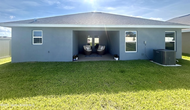 1225 Kylar Dr NE, Palm Bay, FL 32907 - back of house featuring a yard, roof with shingles, stucco siding, and a patio