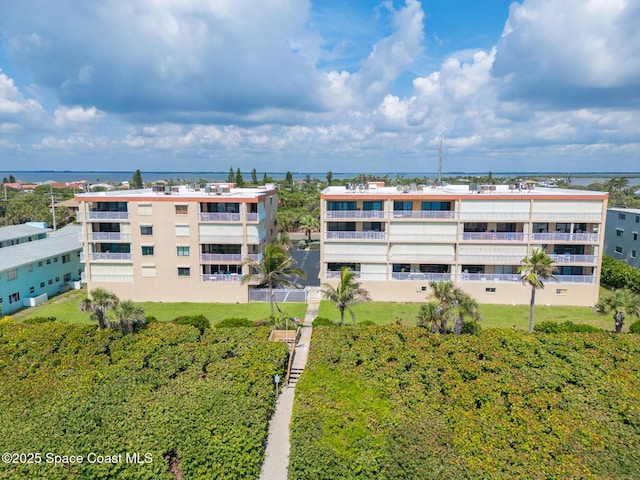 1525 S Atlantic Ave Unit 401, Cocoa Beach, FL 32931 - drone / aerial view of apartment complex and a nearby body of water
