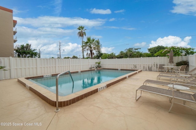 1525 S Atlantic Ave Unit 401, Cocoa Beach, FL 32931 - community pool featuring a patio area and a fenced backyard