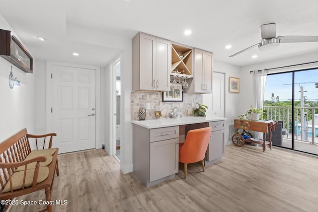 1525 S Atlantic Ave Unit 401, Cocoa Beach, FL 32931 - kitchen featuring light wood-style floors, gray cabinets, open shelves, light countertops, and backsplash