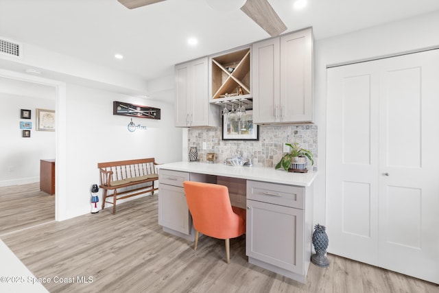 1525 S Atlantic Ave Unit 401, Cocoa Beach, FL 32931 - indoor dry bar featuring light wood-style floors, decorative backsplash, recessed lighting, and built in study area
