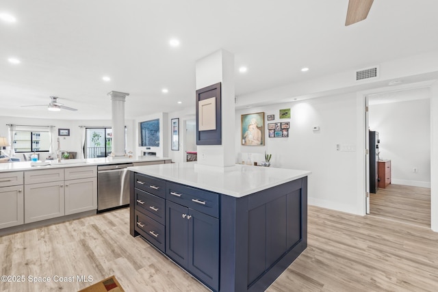 1525 S Atlantic Ave Unit 401, Cocoa Beach, FL 32931 - kitchen with stainless steel dishwasher, a ceiling fan, ornate columns, light countertops, and light wood-style floors