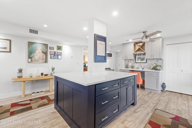 1525 S Atlantic Ave Unit 401, Cocoa Beach, FL 32931 - kitchen featuring light wood finished floors, light countertops, recessed lighting, backsplash, and a ceiling fan