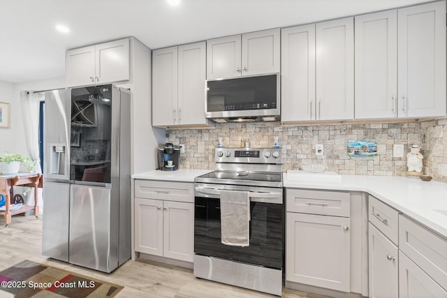 1525 S Atlantic Ave Unit 401, Cocoa Beach, FL 32931 - kitchen featuring appliances with stainless steel finishes, backsplash, light countertops, and recessed lighting
