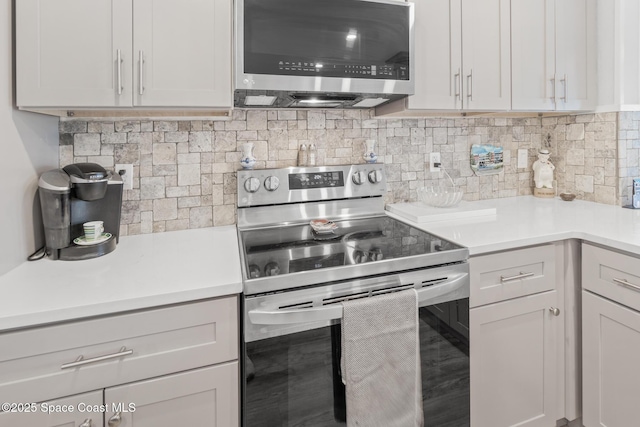 1525 S Atlantic Ave Unit 401, Cocoa Beach, FL 32931 - kitchen featuring stainless steel appliances, light countertops, and backsplash