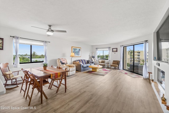 1525 S Atlantic Ave Unit 401, Cocoa Beach, FL 32931 - dining area with light wood-type flooring, a textured ceiling, and ceiling fan