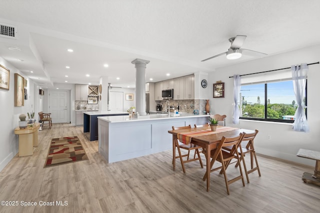1525 S Atlantic Ave Unit 401, Cocoa Beach, FL 32931 - dining room with light wood-style floors, recessed lighting, ceiling fan, and decorative columns