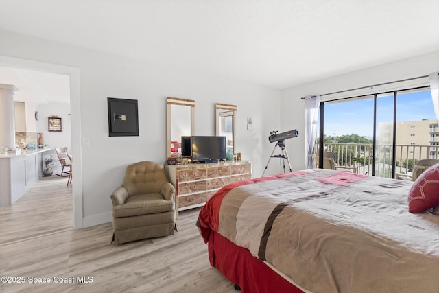 1525 S Atlantic Ave Unit 401, Cocoa Beach, FL 32931 - bedroom featuring access to exterior, light wood-style floors, and electric panel
