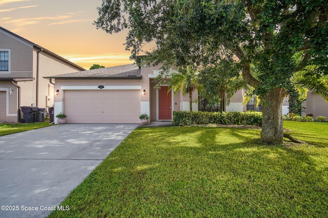 500 Loxley Ct, Titusville, FL 32780 - view of front of home featuring stucco siding, a garage, a yard, and driveway