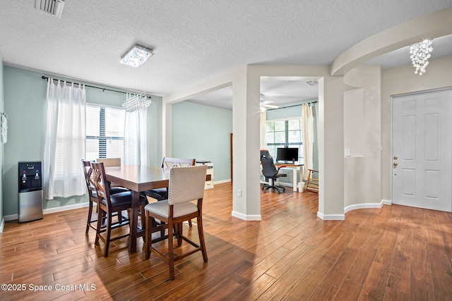 500 Loxley Ct, Titusville, FL 32780 - dining area with wood finished floors, a chandelier, a textured ceiling, an office area, and a ceiling fan