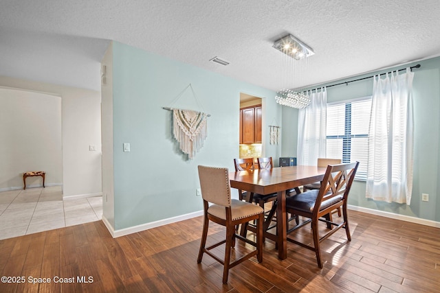 500 Loxley Ct, Titusville, FL 32780 - dining room with light wood-type flooring and a textured ceiling