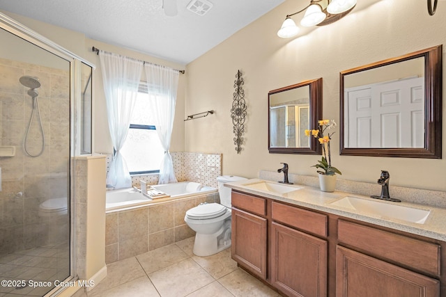 500 Loxley Ct, Titusville, FL 32780 - bathroom with double vanity, a shower stall, a garden tub, and tile patterned flooring