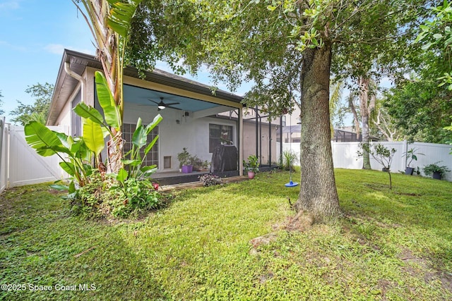 500 Loxley Ct, Titusville, FL 32780 - back of property with a ceiling fan, a fenced backyard, and a sunroom