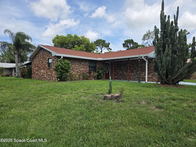 744 John Carroll Ln, Melbourne, FL 32904 - ranch-style house with a front lawn and brick siding
