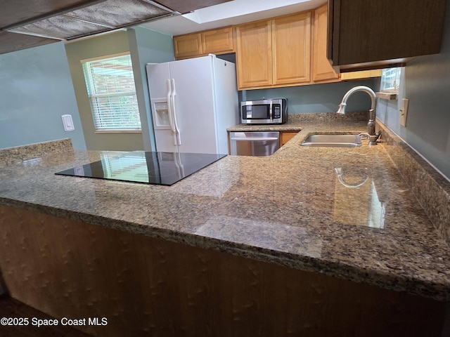 744 John Carroll Ln, Melbourne, FL 32904 - kitchen with appliances with stainless steel finishes, light brown cabinetry, dark stone countertops, and range hood