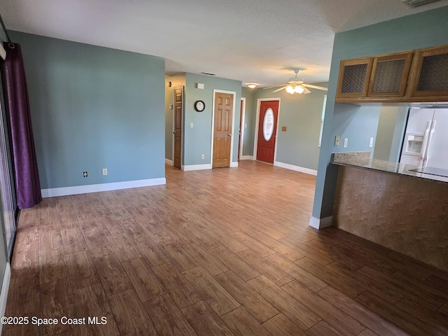744 John Carroll Ln, Melbourne, FL 32904 - unfurnished living room with ceiling fan and dark wood-style flooring